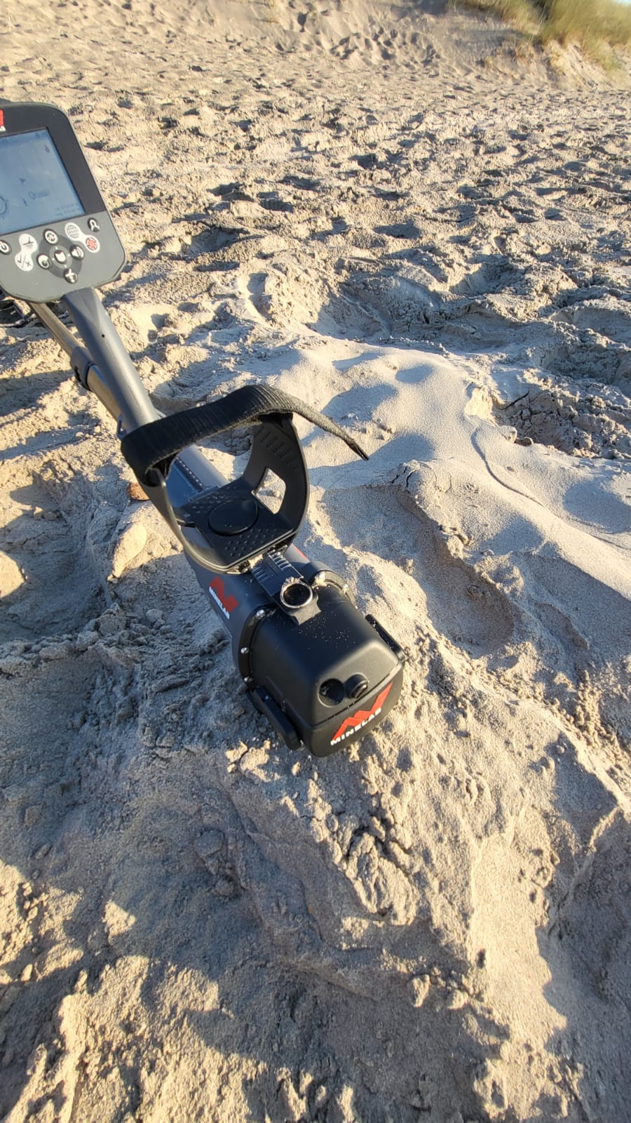 A metal detector standing on the sand at Curracloe beach during the early morning search