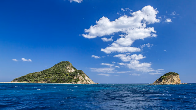 Turquoise water over sand and flat rocks at Cala Comte beach in Ibiza, the kind of cala where a lost ring settles close to where it fell