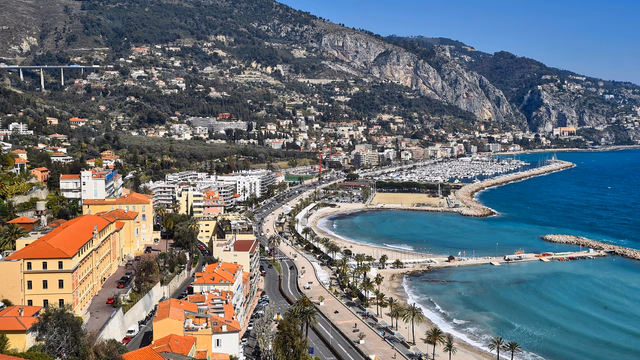 The colourful old town of Menton rising above the sea on the French Riviera, with the small sheltered beach below where a lost ring would sit in the shingle